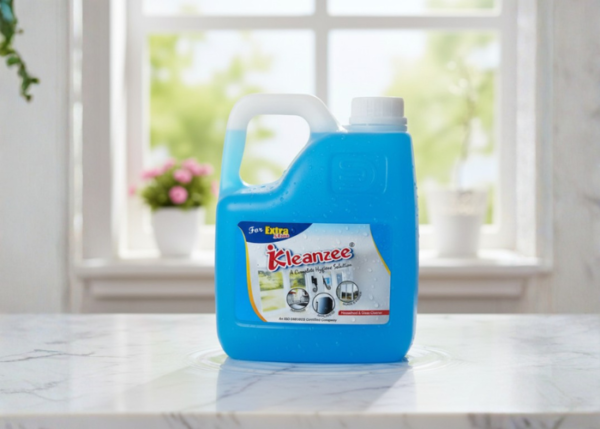 A large blue 5-liter container of IKleanzee glass cleaner liquid with a white handle and cap, positioned on a white marble ledge.