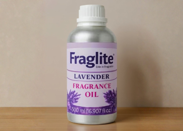 A 500 ml silver bottle of Fraglite Lavender Fragrance Oil with a purple label and lavender flower graphics on a wooden shelf.