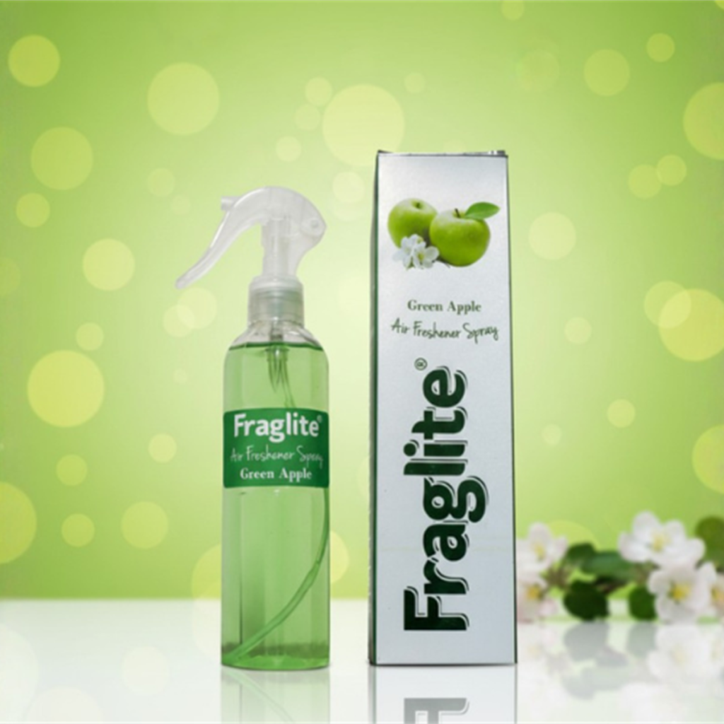 A green Fraglite spray bottle and box against a soft green background with green apples and white apple blossoms.