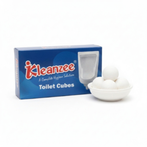 A blue box of Kleanzee Toilet Cubes featuring a urinal illustration, placed next to a small white bowl containing four white spherical toilet cubes.